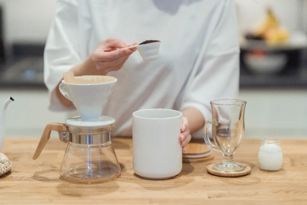 Woman brewing coffee